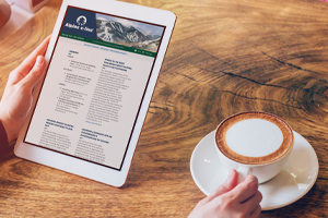 Reader with Alpine's community banking newsletter