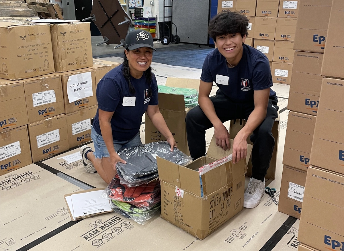 Picture of teacher and student opening boxes